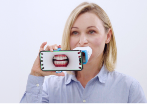 Orthodontic consultation with doctor reviewing digital dental images alongside a patient