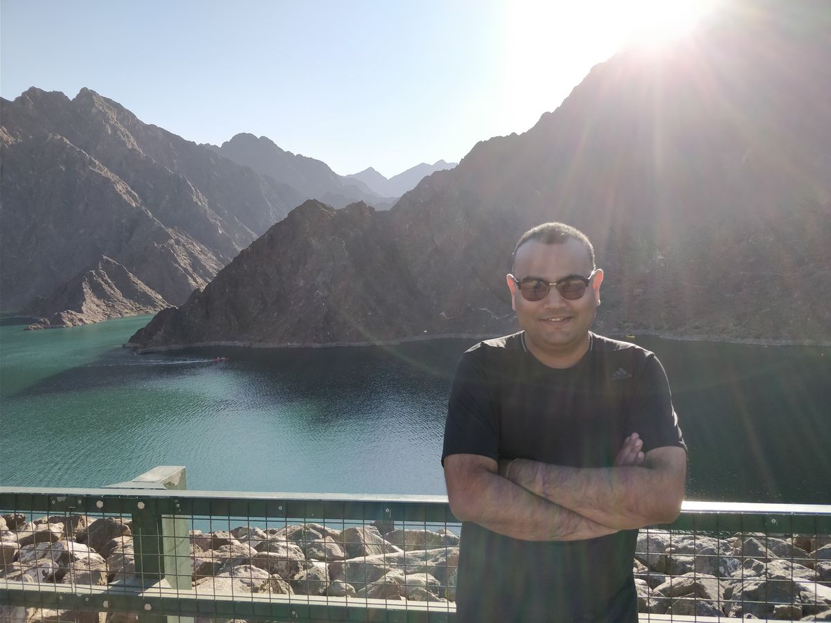 Dr. Singh at a turquoise mountain lake